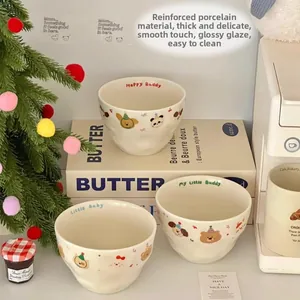 Detailed view of matte cream ceramic bowls featuring cute cartoon animal patterns