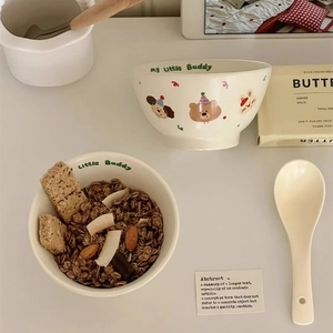 Detail of ceramic breakfast bowl with cute animal prints and my little Buddy text