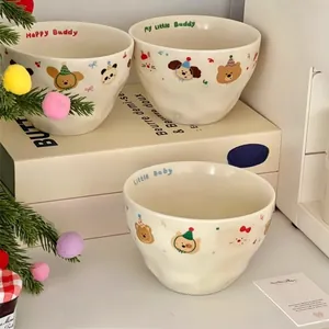Close-up of matte cream ceramic bowl featuring cute cartoon bears and textured finish
