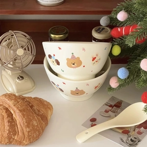 Close-up of cute cartoon animal pattern on warm white ceramic breakfast bowls