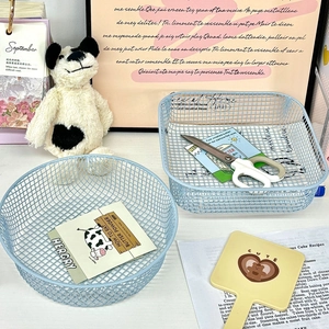 Detail of light blue metal mesh desk organizer set with round and rectangular baskets