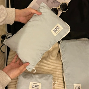 Close-up of waterproof light blue travel organizer bags with zippers and woven labels