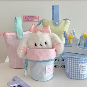 Detailed view of canvas pencil pouch with plush bunny doll and creative smile clips