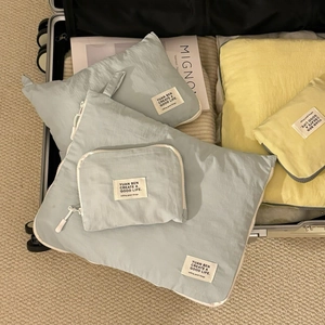Waterproof travel organizers neatly packed in a suitcase with soft lighting and magazines