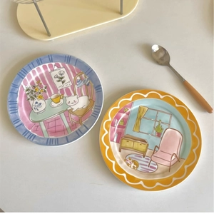 Cute ceramic plates with hand-drawn cartoon cat illustrations for dessert or breakfast