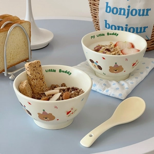 Detail of cream ceramic cereal bowl set with cute cartoon bear and rabbit patterns