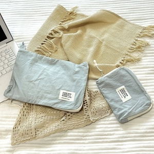 Macro detail of two light blue travel storage bags on a laptop keyboard background