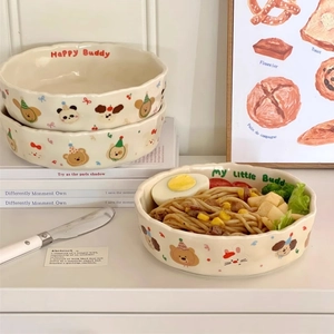 Detail of a wavy edge ceramic bowl with cute animal illustrations and creamy matte finish