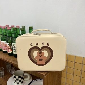 Detail of cream cosmetic bag with cute bear print and sturdy metal zippers