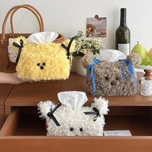 Close-up of cute plush bear tissue box covers in yellow, brown, and white soft faux fur