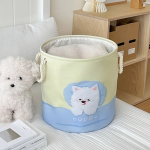 Detail of blue and yellow fabric laundry basket with puppy print and cotton rope handles