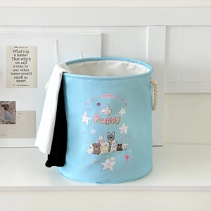 Detail of light blue laundry basket with cartoon dog print and durable rope handles