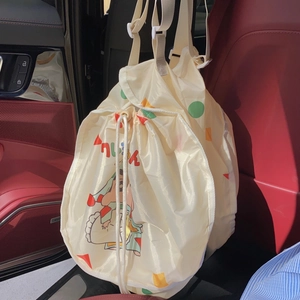 Detail view of Crayon Shin-chan cartoon drawstring organizer bag on car seat back