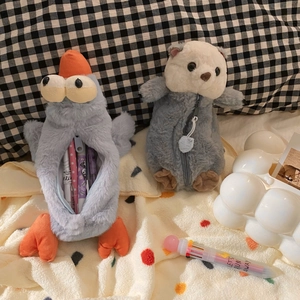 Detail showing plush duck pencil case zipper opening with many pens stored inside