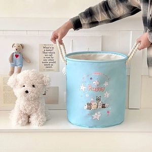 Detail of blue cartoon laundry basket with thick rope handles and puppy prints