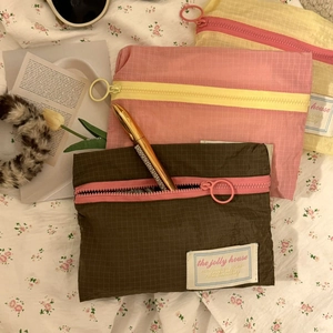 Detail of plaid travel organizers with contrast zippers and circular pullers