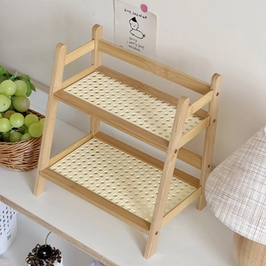 Detail of double-layer cream rattan desktop shelf with natural wood frame and mesh design