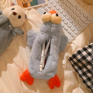 Detail of plush blue duck pencil case showing spacious interior with pens inside