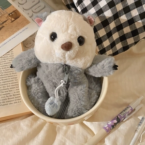 Detailed view of sea otter plush pencil case with zipper closure on a desk setup