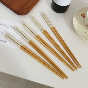 Five pairs of Japanese style bamboo chopsticks with colorful polka dots on white tips