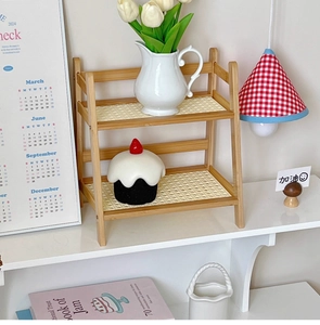 Close-up of double-layer wooden cream desktop shelf with rattan texture for home decor