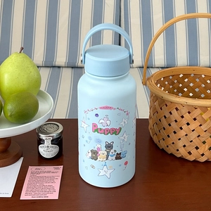 Detail of light blue puppy insulated tumbler with portable handle and cute illustrations