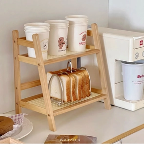 Detail of a 2-tier cream rattan desktop shelf with bamboo frame for kitchen storage