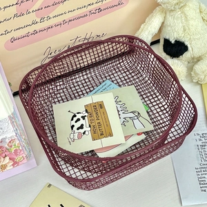 Detail of burgundy iron mesh storage baskets showing high-quality metallic grid texture