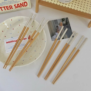 Macro shot of Japanese style bamboo chopsticks with cream and colorful polka dot handles