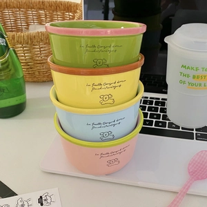 Set of four colorful ceramic bowls with puppy illustrations and French lettering