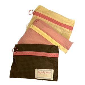 Three-piece travel storage bag set in yellow, orange, and brown tear-resistant nylon