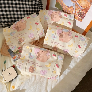 Detail of four detachable cream canvas organizers with cute cartoon puppy and moon prints