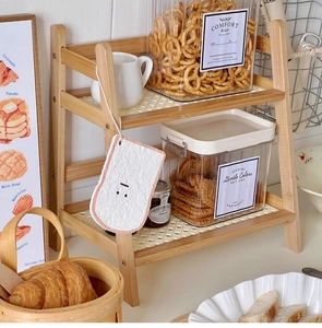 Macro view of double-tier cream rattan desktop rack with bamboo frame and woven liners
