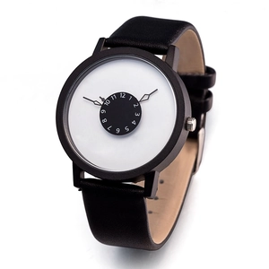 Detail of minimalist quartz watch featuring a black leather strap and unique numeric dial