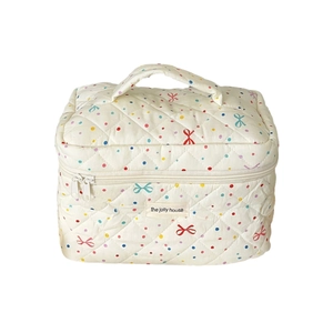 Quilted cotton cosmetic bag with colorful polka dots and bow patterns on white background