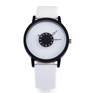 Macro view of minimalist quartz watch with reverse black dial and white leather strap