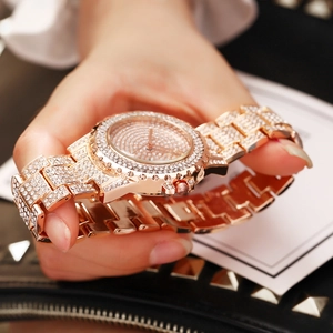 Close-up of luxury rose gold watch with sparkling rhinestones and metal band details