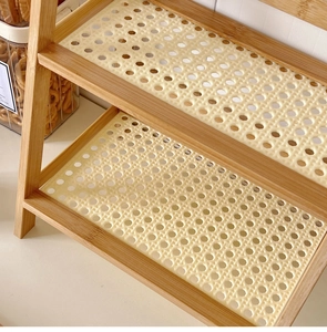 Close-up of cream-colored woven rattan texture and wood grain on a double-layer desk shelf