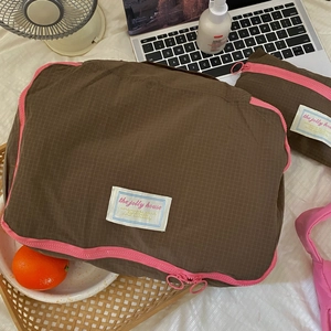 Detailed close-up of a waterproof nylon travel organizer bag with mesh and pink zipper