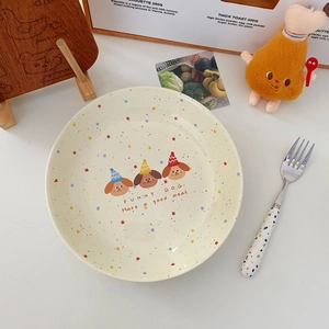 Close-up of cute ceramic plate with colorful stars and funny cartoon dog patterns
