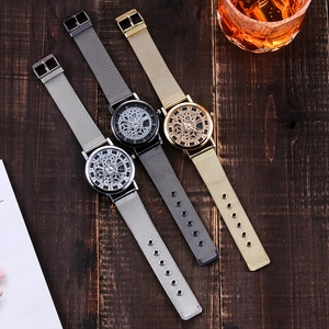 Three men's quartz watches with Milanese mesh bands displayed on a dark wood background