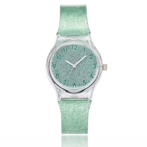 Detail of light green glitter dial with clear Arabic numerals and silicone strap