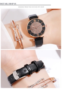 Vue détaillée de la montre à cadran étoilé avec bracelet en cuir noir et gourmette cristal