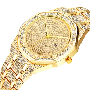 Macro view of gold luxury watch with octagonal diamond-set bezel and date display
