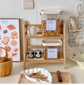 Detail of a 2-tier cream wood shelf featuring a white hollowed-out breathable base plate