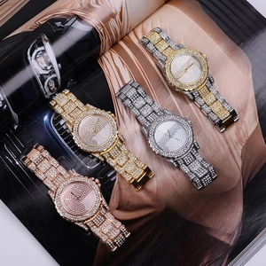 Close-up of luxury iced-out diamond watches in gold, silver and rose gold metal finishes