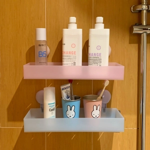 Detail of two-piece matte wall-mounted bathroom shelves in pink and blue colors