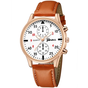 Detail of rose gold men's watch with brown leather strap and white stitching