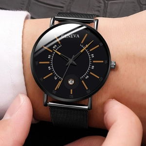 Detail of Geneva quartz watch with black mesh band and golden markers on male wrist