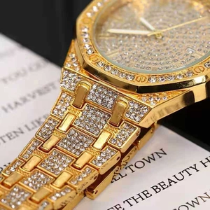 Macro detail of luxury gold watch with sparkling rhinestones and octagonal bezel